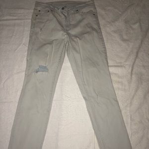 Light blue jeans with distressed knee.